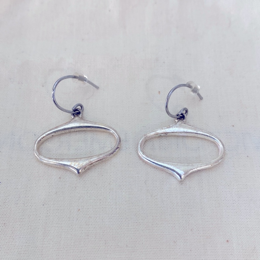 Silver toned earrings oval shape.